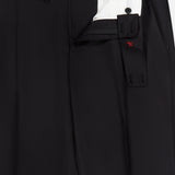 Presenting the 150′s Timeless Casalnuovo Trouser Pant by ISAIA: expertly crafted in Italy, these black wool dress pants feature a fly open to reveal a white inner lining with striking red stitching accents. Two adjustable black waistband tabs are visible next to the zipper area, highlighting ISAIA’s refined craftsmanship and contemporary style.