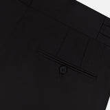 Close-up of the back of the ISAIA 150′s Timeless Casalnuovo Trouser Pant in black, made in Italy, featuring a single welt pocket with a button and belt loops along the waistband against a plain white background.