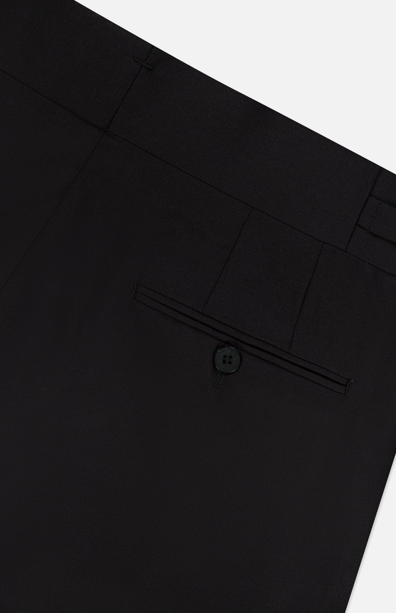 Close-up of the back of the ISAIA 150′s Timeless Casalnuovo Trouser Pant in black, made in Italy, featuring a single welt pocket with a button and belt loops along the waistband against a plain white background.
