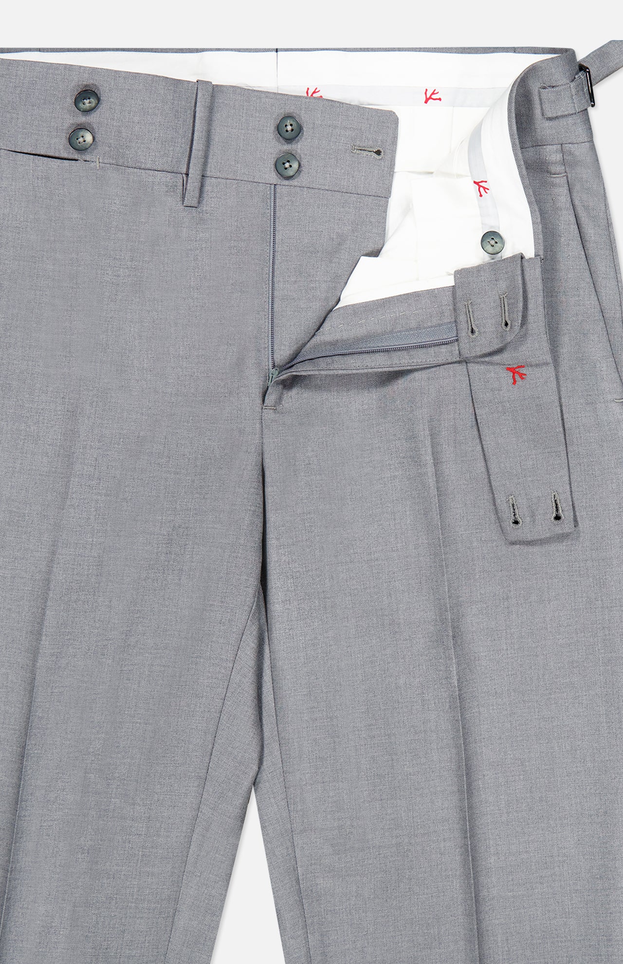 A pair of ISAIA 150′s Timeless Casalnuovo Trouser Pants in light gray wool, featuring a tailored fit with an extended tab waistband, belt loops, and visible interior white lining accented by red stitching. Made in Italy, the trousers are partially unzipped and neatly folded.