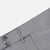 Close-up of the ISAIA 150′s Timeless Casalnuovo Trouser Pant in light grey, highlighting the waistband, dual buttons, belt loop, and part of the front pocket against a white background. Crafted in Italy from fine wool for an elegant and refined finish.