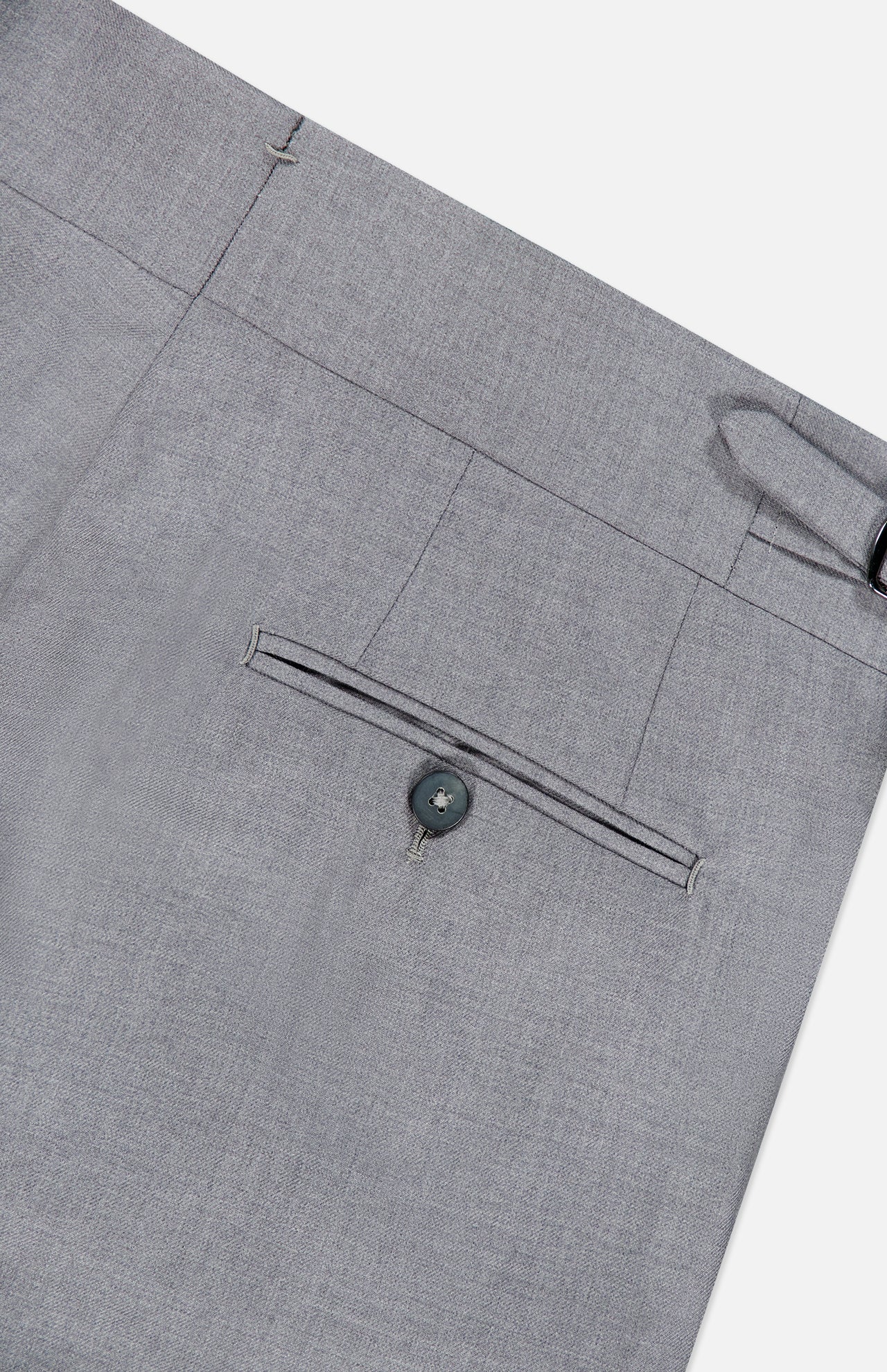 Close-up of the ISAIA 150′s Timeless Casalnuovo Trouser Pant in light grey, featuring the back pocket with button closure, a belt loop, and part of the waistband. The smooth, fine-textured fabric highlights the refined quality of these Italian-made wool trousers.
