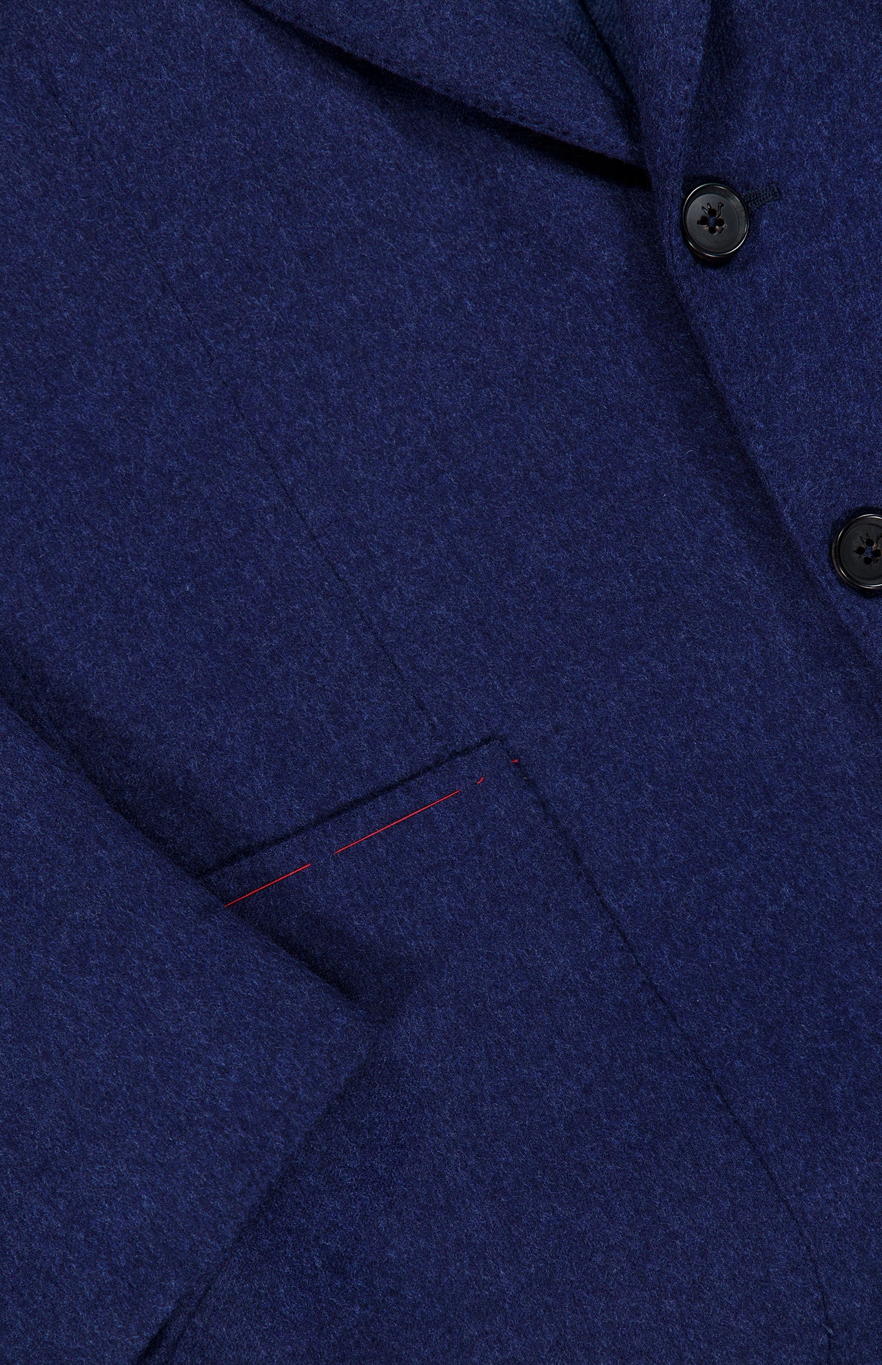 Close-up of the ISAIA Australian Merinos Double Face Sportcoat, made in Italy, featuring two black buttons, a classic lapel, and a front pocket with subtle red stitching detail on the wool-blend jacket.