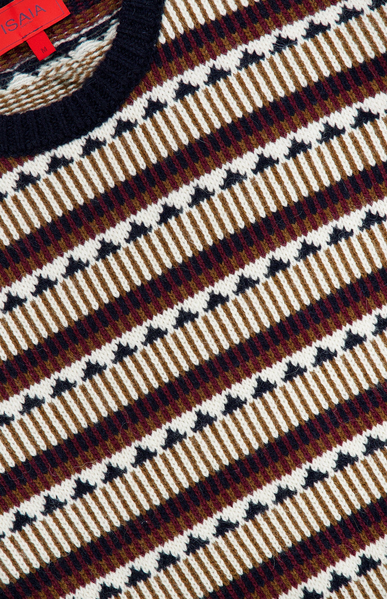 A close-up of the Bliss Wool and Alpaca Sweater by ISAIA, showcasing its multicolored diagonal stripes in white, brown, maroon, and black. This crew neck sweater features a ribbed black collar and a visible red tag at the neckline.