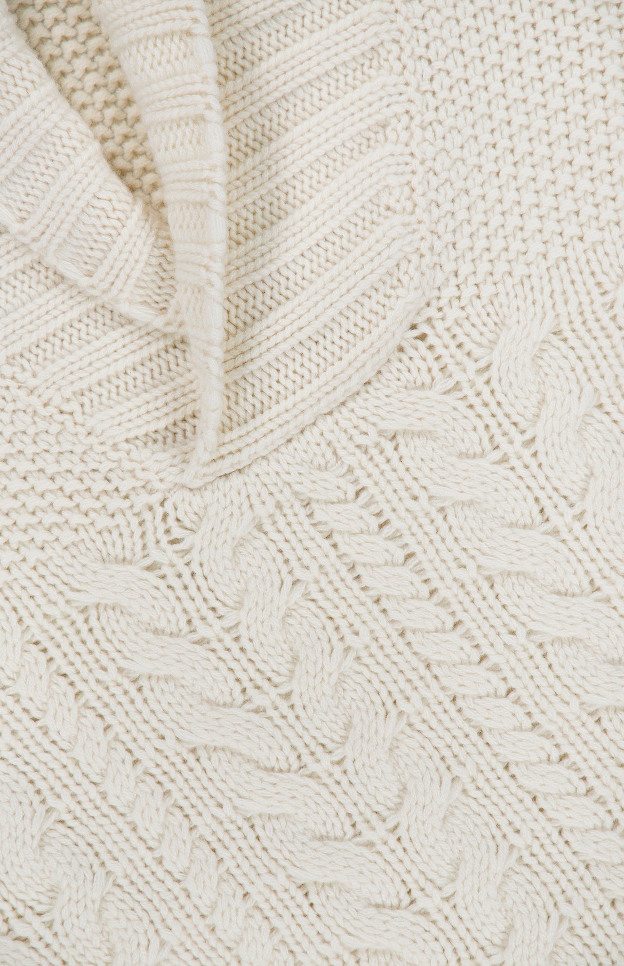 Close-up of the ISAIA Cashmere Shawl Collar Sweater in a cream hue, showcasing a blend of ribbed, cable knit, and textured stitch patterns.