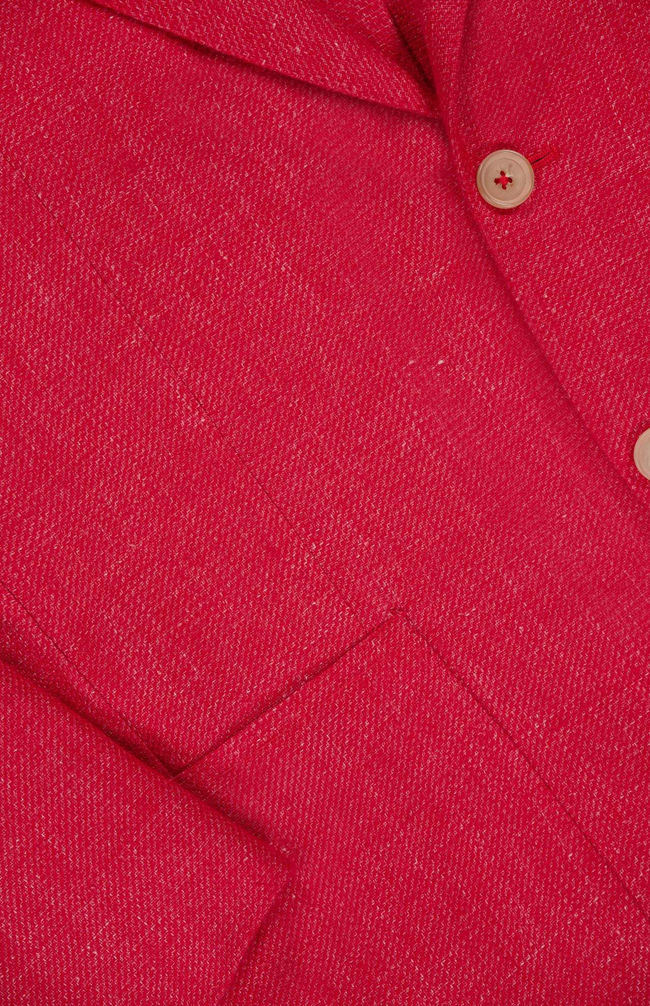 Close-up of the ISAIA Cashsilk & Linen Sportcoat, made in Italy, showing its textured red fabric, pocket, lapel, and two beige buttons.