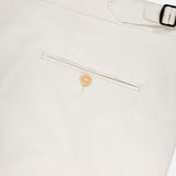 Close-up of ISAIA’s Cotton & Cashmere Comfort Trouser Pant, showcasing the off-white back with a welt pocket, tan button, and adjustable side tab with silver buckle—men's pants featuring comfort and refined details.