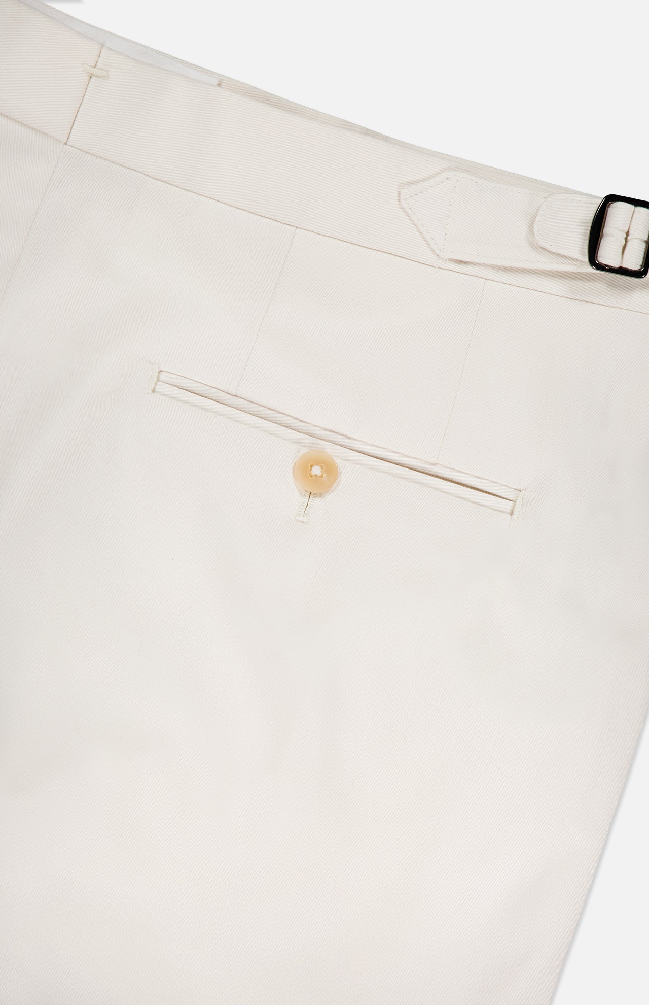 Close-up of ISAIA’s Cotton & Cashmere Comfort Trouser Pant, showcasing the off-white back with a welt pocket, tan button, and adjustable side tab with silver buckle—men's pants featuring comfort and refined details.