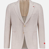 The ISAIA Cotton Linen Jersey Sportcoat is a light beige jacket with notched lapels, two-button closure, patch pockets, beige lining, and small red accents on the left lapel and right cuff. Made in Italy; shown on a plain background.
