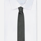 A neatly folded white dress shirt with a pointed collar, paired with the ISAIA Dot Pattern Tie in dark green silk, featuring a subtle dotted design, displayed against a light background.