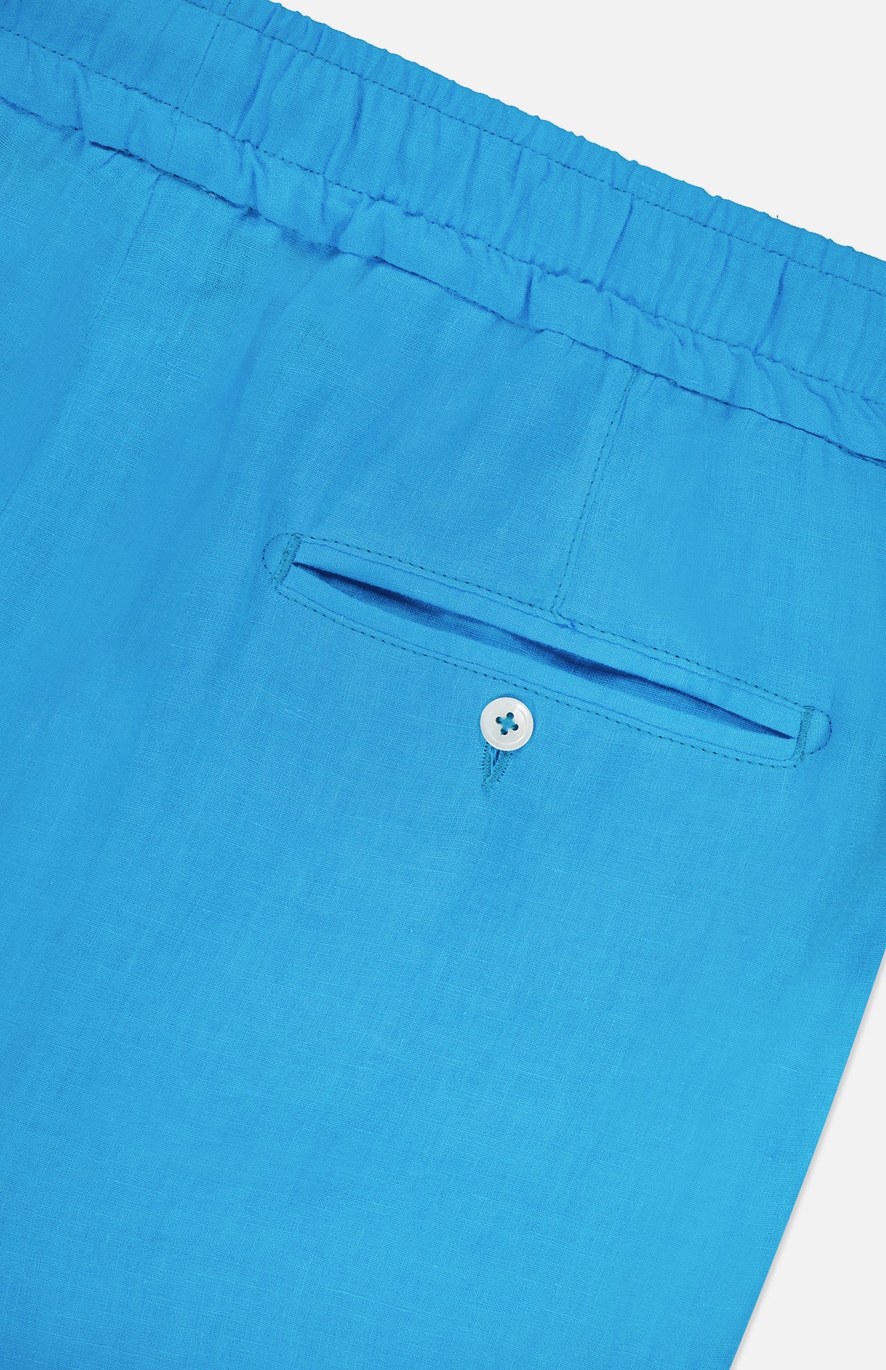 Close-up of the back pocket on ISAIA's Drawstring Wide Leg Linen Corallo Trouser Pant in bright blue, featuring an elastic waistband and button closure—ideal for effortless vacation style.