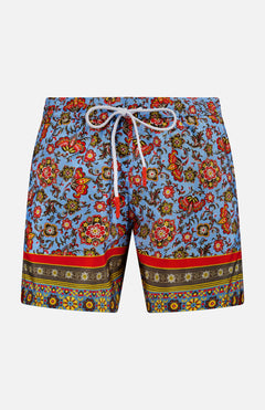 ISAIA's Drawstring Printed Swim Trunk features a vibrant floral and paisley print on light blue, white drawstring waistband, and multicolored bands at the hem—perfect for standout men's beach style.