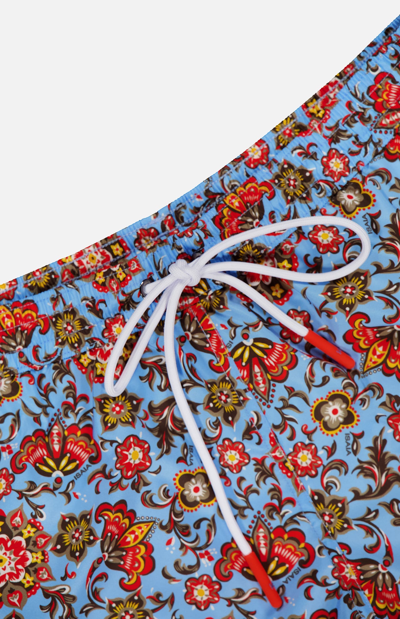 Close-up of ISAIA Drawstring Printed Swim Trunk with a blue base and colorful floral pattern in red, yellow, and brown; features a white drawstring waistband—perfect men’s swimwear for vibrant beach style.