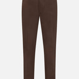 The Dynamic Comfort Casalnuovo Trouser Pant by ISAIA features a dark brown Neapolitan tailored design with a tapered leg, front crease, side buckles, button closure, and belt loops. Expertly crafted in Italy, the trousers are showcased against a plain white background.