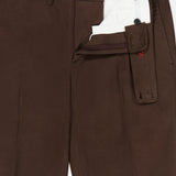 The Dynamic Comfort Casalnuovo Trouser Pant by ISAIA features a dark brown hue with a partially open waistband that reveals white interior lining and button closures. Made in Italy in the classic Neapolitan trousers style, these pants also include a side adjuster strap with buttonholes for a perfect fit.