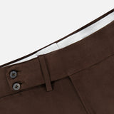Close-up of the waistband of a pair of ISAIA Dynamic Comfort Casalnuovo Trouser Pants in dark brown, featuring two dark buttons, a belt loop, and a white inner lining, set against a plain light background. These trousers exemplify ISAIA’s classic craftsmanship and refined Italian style.