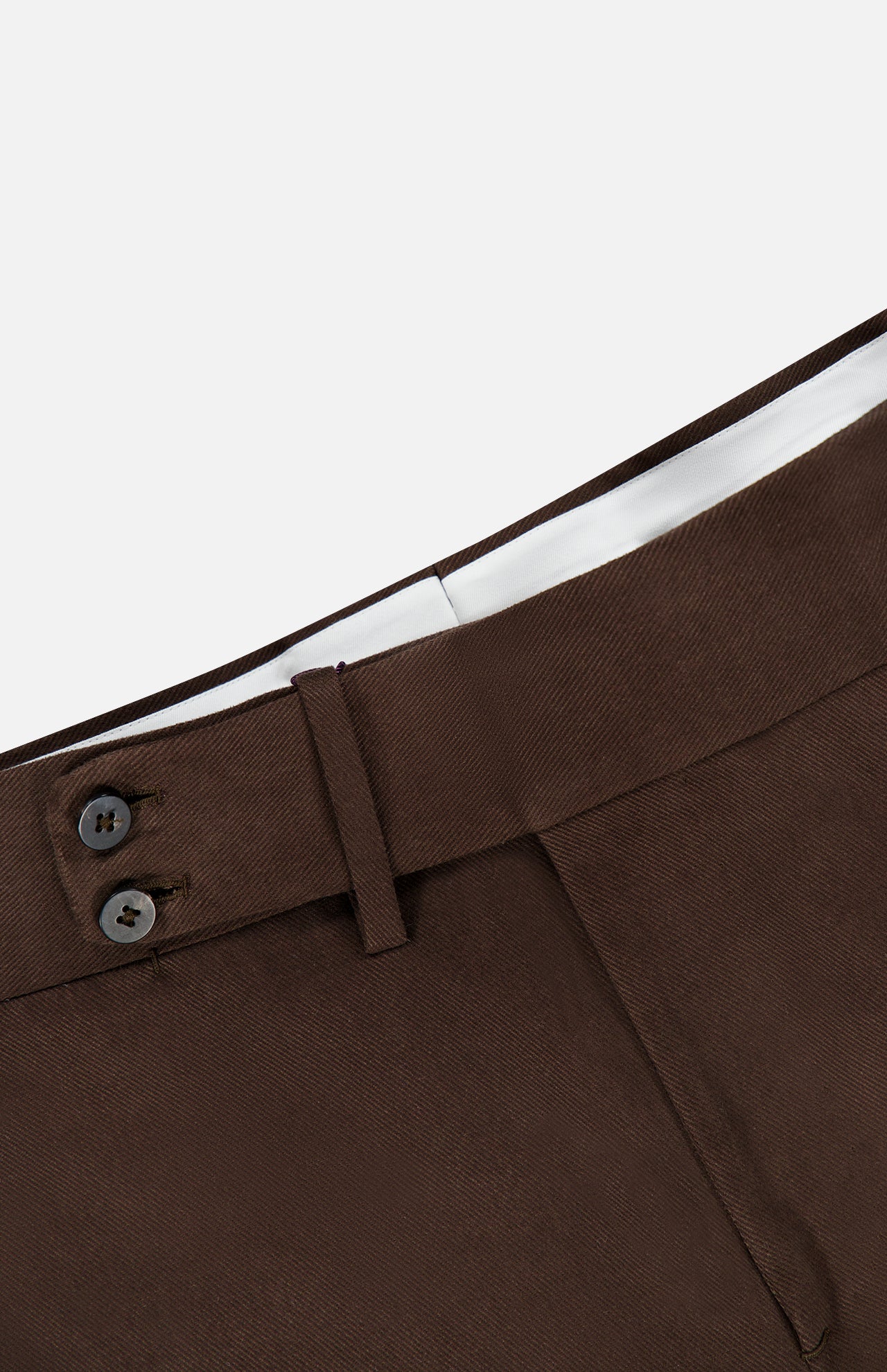 Close-up of the waistband of a pair of ISAIA Dynamic Comfort Casalnuovo Trouser Pants in dark brown, featuring two dark buttons, a belt loop, and a white inner lining, set against a plain light background. These trousers exemplify ISAIA’s classic craftsmanship and refined Italian style.