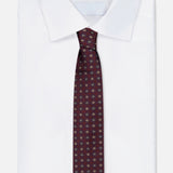A neatly folded white dress shirt with a classic collar, paired with the ISAIA Floral Pattern Tie. The tie is a dark red silk design featuring an elegant floral motif. The background is plain white.
