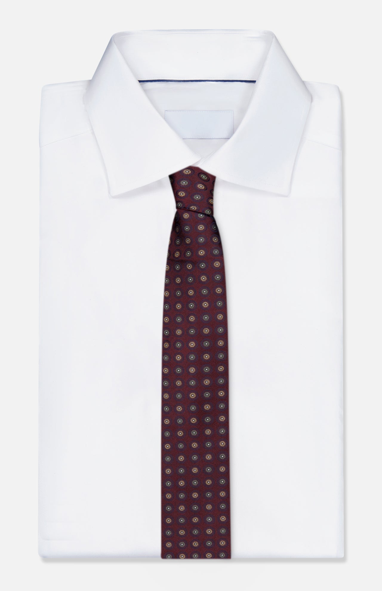 A neatly folded white dress shirt with a classic collar, paired with the ISAIA Floral Pattern Tie. The tie is a dark red silk design featuring an elegant floral motif. The background is plain white.