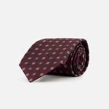 A rolled-up ISAIA Floral Pattern Tie in burgundy, featuring a repeating small circular pattern in yellow and blue, displayed on a plain white background.