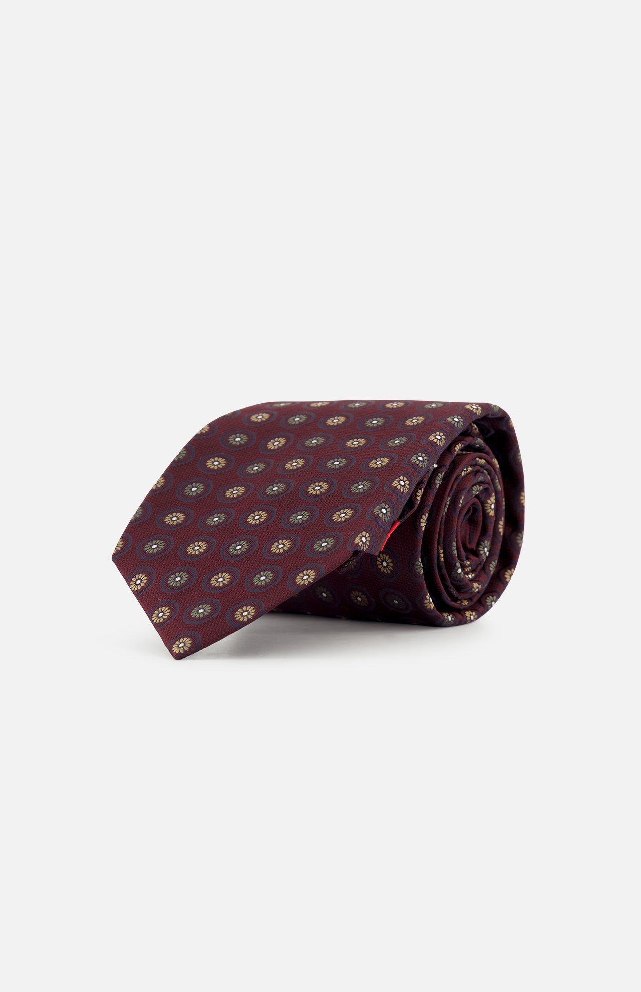 A rolled-up ISAIA Floral Pattern Tie in burgundy, featuring a repeating small circular pattern in yellow and blue, displayed on a plain white background.