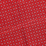The ISAIA Floral Print Pocket Square is crafted in Italy from red silk and features a diagonal pattern of small white and black flowers. The surface has a subtly creased appearance.