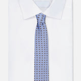 A neatly folded white dress shirt with a crisp collar pairs with an ISAIA Floral Print Neck Tie, displayed on a white background.