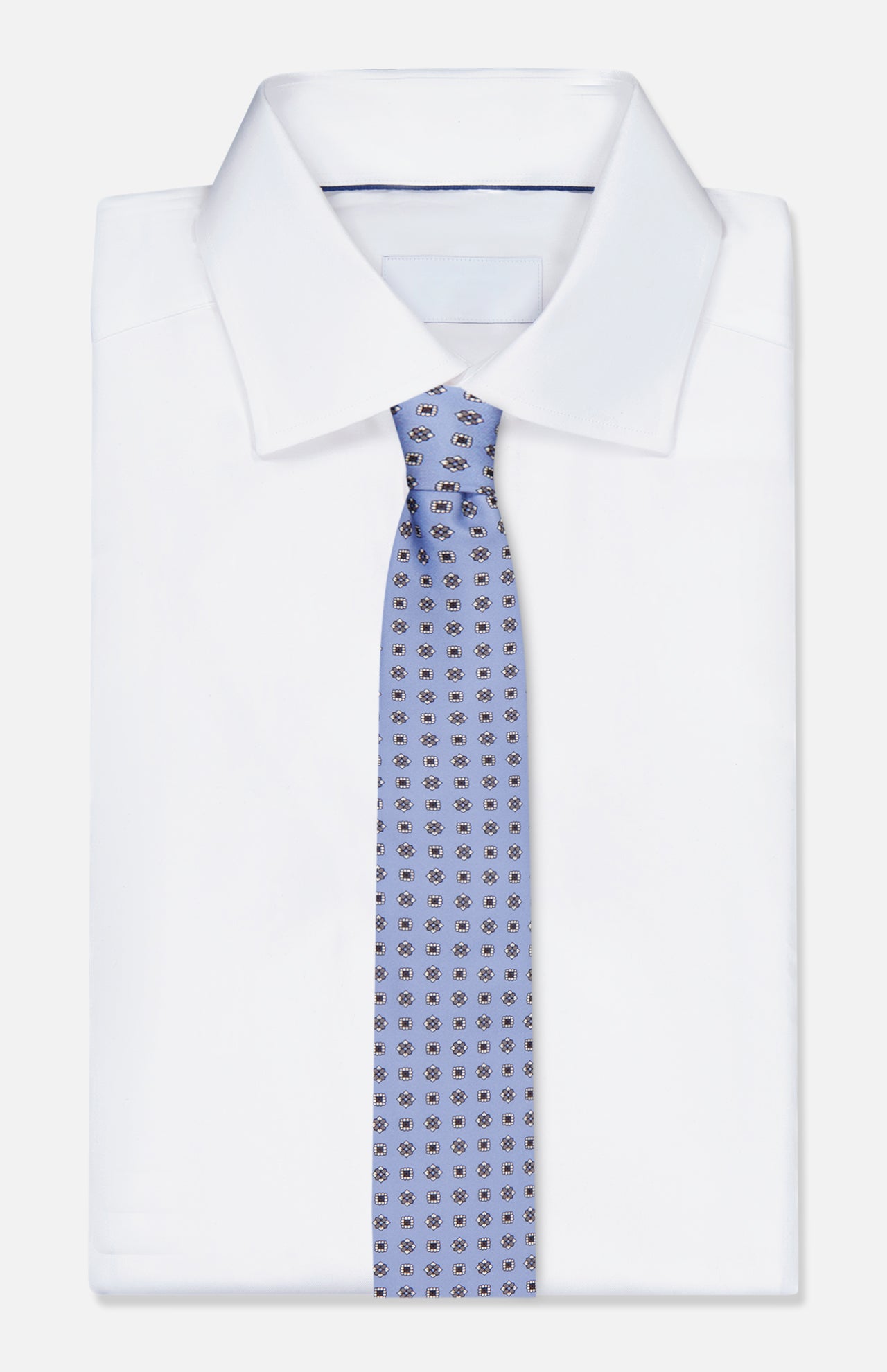 A neatly folded white dress shirt with a crisp collar pairs with an ISAIA Floral Print Neck Tie, displayed on a white background.