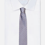 A neatly folded white dress shirt with a classic collar is paired with an ISAIA Floral Print Silk Tie, displayed on a plain white background.