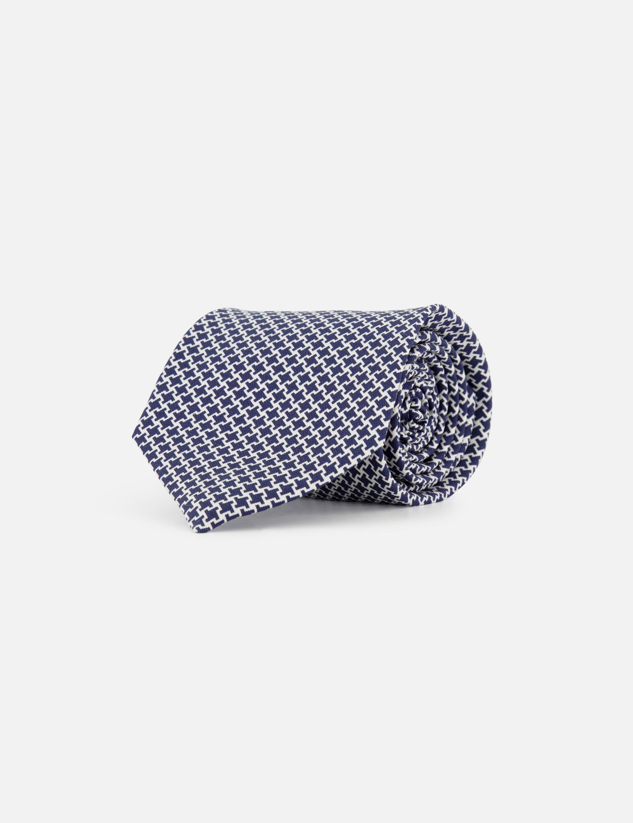 The ISAIA Geometric Print Neck Tie, crafted from silk in blue and white with a geometric pattern, is shown rolled up against a plain white background.