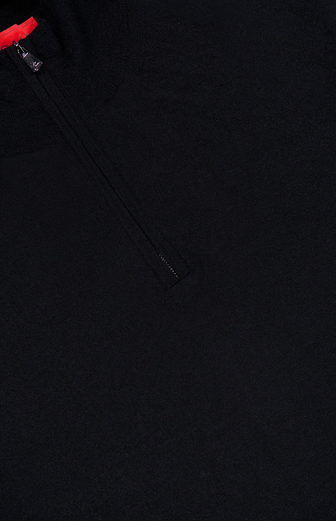 Close-up of the ISAIA Light Cashmere Silk Quarter Zip Sweater in black, crafted from a luxurious blend of cashmere and silk and featuring a partial zipper with a small red fabric detail at the collar.