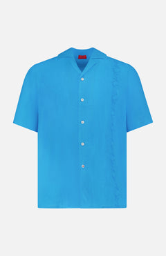 The ISAIA Linen Coral Embroidery Shirt is a relaxed-fit, short-sleeve blue linen button-up, featuring white buttons and a subtle ruffle detail along the right side—ideal for effortless vacation style.