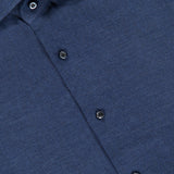 Close-up of the Lux Cashcotton Flannel Dress Shirt by ISAIA, featuring a blue hue with dark buttons and a signature red ISAIA label sewn inside the collar. The shirt’s smooth, subtly textured fabric highlights the refined elegance and expert craftsmanship characteristic of Italian dress shirts.