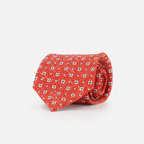 The ISAIA Multicolor Silk Floral Tie, featuring a red base with white and blue micro floral patterns, is shown rolled up on a plain white background.