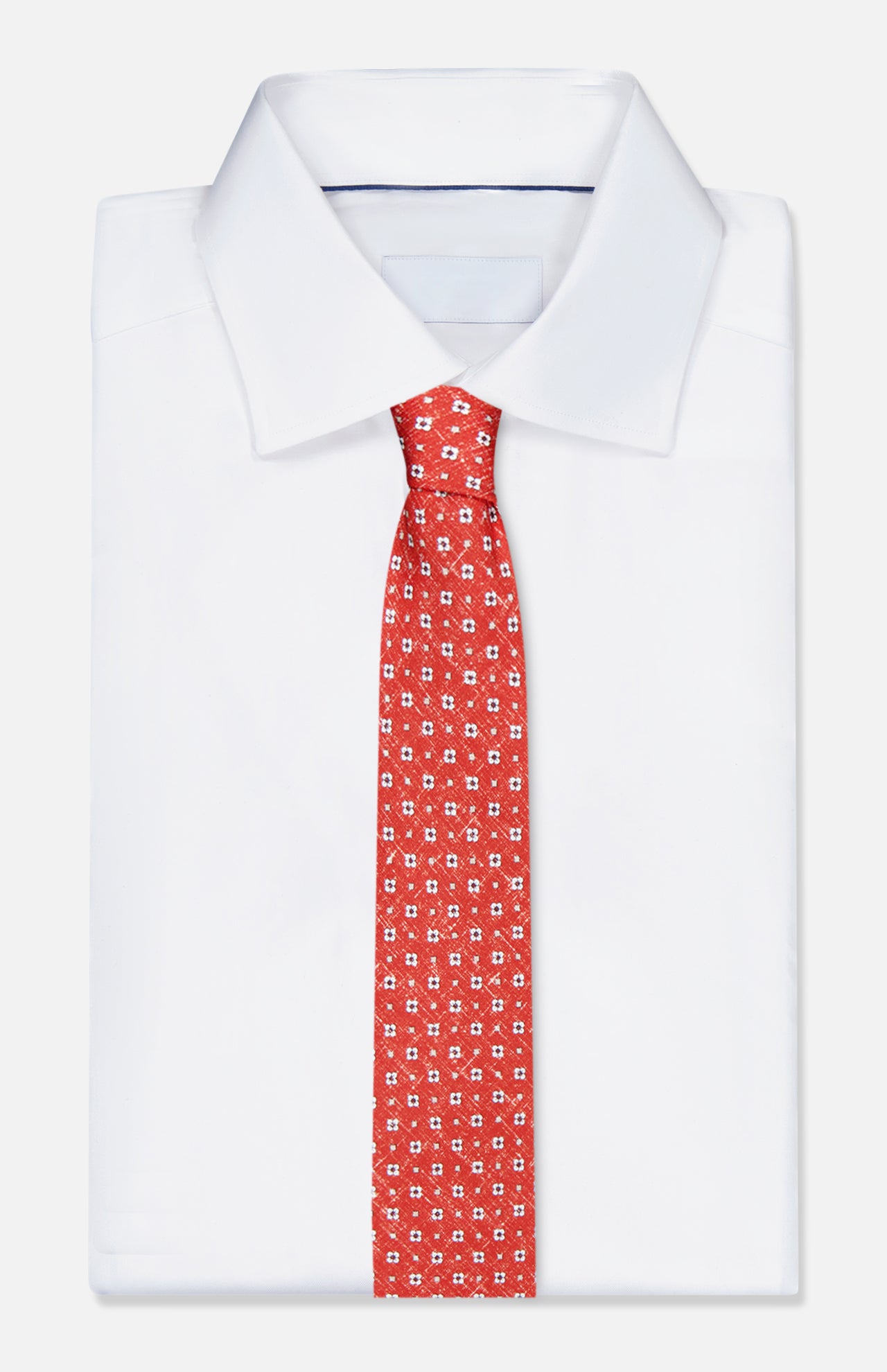 A crisply folded white dress shirt with a sharp collar is paired with the ISAIA Multicolor Silk Floral Tie, displayed on a plain white background.