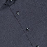 A close-up of the ISAIA Mussola Cotton Dress Shirt in dark grey showcases its collared design and visible black buttons. Made from easy-care cotton, this shirt is accented with a small red tag featuring text near the collar.
