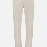 Presenting the ISAIA Napoli Stretch Denim Jeans: a pair of light beige, slim-fit jeans featuring a tapered leg, five-pocket styling, button closure, and belt loops. Crafted from soft stretch cotton denim and showcased against a plain white background.