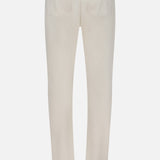 The Napoli Stretch Denim Jeans by ISAIA are shown from the back in a beige hue, featuring two rear pockets and a distinctive small red patch on the waistband. Crafted from soft cotton denim, they offer everyday comfort with a classic straight-leg fit.