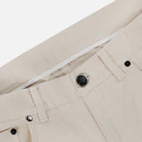 Close-up of the waistband and front pocket of the ISAIA Napoli Stretch Denim Jeans in beige cotton denim, featuring a metal button, belt loops, and detailed stitching. The fabric showcases a subtle twill texture.