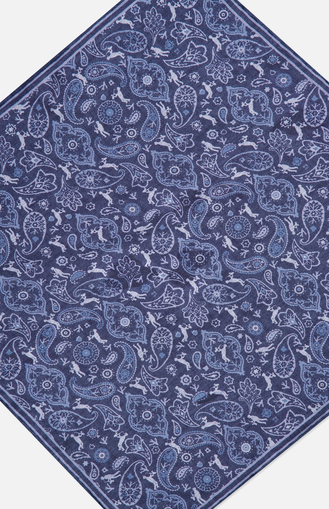 A hexagonal rug featuring a detailed blue and white paisley and floral pattern on a dark blue background, inspired by the refined elegance of the Paisley Pocket Square from ISAIA.