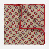 The ISAIA Paisley Print Pocket Square is a beige linen accessory with a red and black paisley design, red piping, and a subtle red embroidered logo on the top right. An elegant Italian-made choice for refined style.