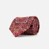 The ISAIA Paisley Neck Tie, crafted in Italy from pure silk, showcases a rolled dark red design adorned with an intricate paisley pattern in gold and green hues, set against a plain white background.