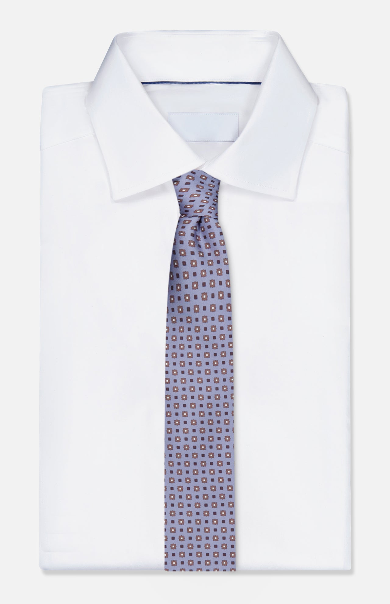 A neatly folded white dress shirt with a pointed collar, paired with ISAIA’s Pattern Neck Tie—an exquisitely made-in-Italy silk accessory in light blue, featuring a small geometric square design on a white background.