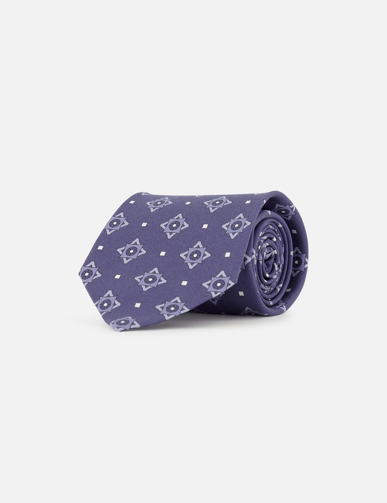 The ISAIA Pattern Neck Tie, crafted in purple silk with a repeating light blue geometric star motif, is shown rolled up against a plain white background.