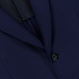 Close-up of the ISAIA Scuba Wool Comfort Suit Jacket, showcasing its dark blue hue with a focus on the lapel, two black buttons, and a glimpse of the pocket and inner lining.