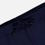 Close-up of the waistband of the ISAIA Scuba Wool Comfort Suit Trouser in navy, showcasing an elastic band and a front drawstring tied in a bow. The ends of the drawstring are adorned with small red accents, highlighting the refined craftsmanship of these Italian-made wool-blend pants.