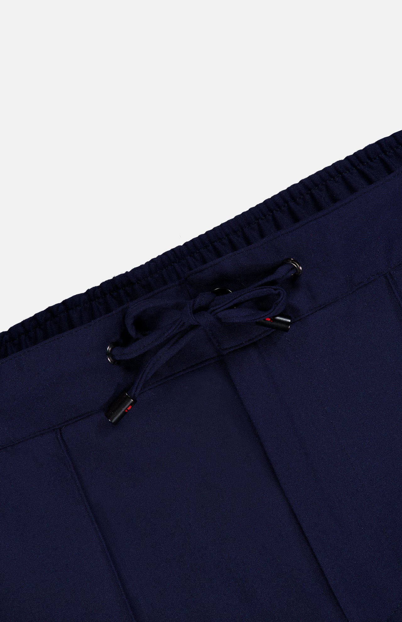 Close-up of the waistband of the ISAIA Scuba Wool Comfort Suit Trouser in navy, showcasing an elastic band and a front drawstring tied in a bow. The ends of the drawstring are adorned with small red accents, highlighting the refined craftsmanship of these Italian-made wool-blend pants.