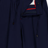 The ISAIA Scuba Wool Comfort Suit Trouser is crafted in a navy blue wool-blend and features an elastic waistband with drawstrings, button, and zip fly. The waistband showcases a signature red and white inner trim, while pleats on each leg add tailored sophistication. Expertly made in Italy for outstanding quality and style.