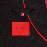 Close-up of the Soft Boucle Alpaca & Wool Sportcoat’s interior, showcasing a red ISAIA label, a triangular black flap with a red button, sleek black lining, and bold red piping. This expertly crafted ISAIA jacket is made in Italy from an alpaca wool blend.