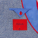 A close-up of the inner lining of the Soft Boucle Alpaca & Wool Sportcoat by ISAIA highlights its refined craftsmanship, featuring a red-bordered ISAIA label, a blue flap with a red button, and red piping along the edge—details that exemplify this Italian-made alpaca wool-blend jacket.